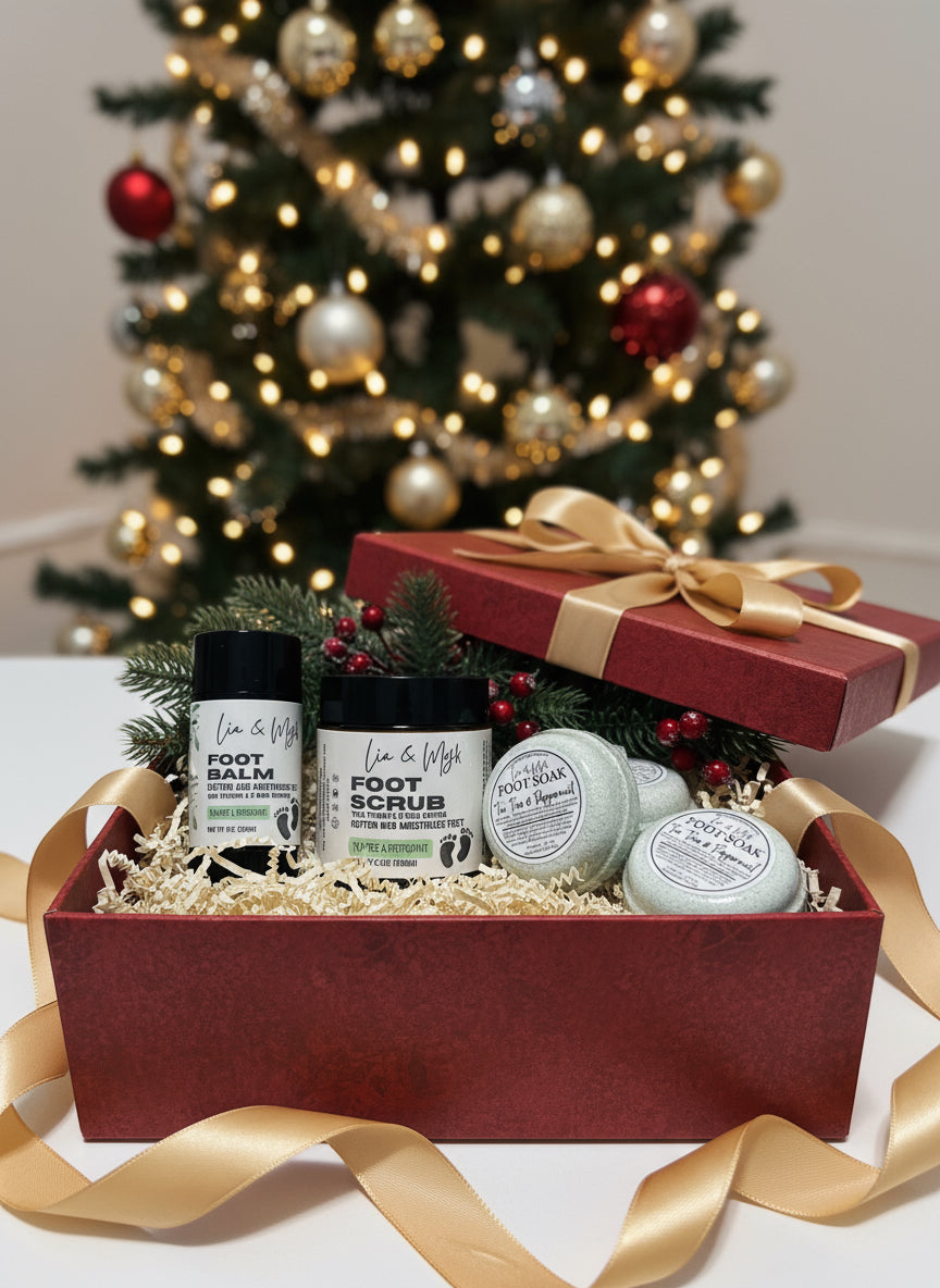 Set of foot care products including balm, scrub, and soap on a Christmas box with a Christmas tree  background.